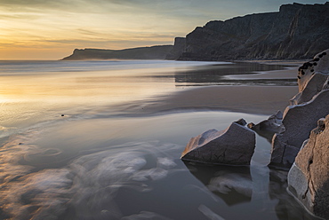 Sunset over a deserted Mewslade Bay in Gower in winter, South Wales, United Kingdom, Europe