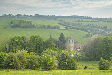 Rural church in beautiful Cotswolds countryside on a hazy spring morning, Naunton, Gloucestershire, England, United Kingdom, Europe