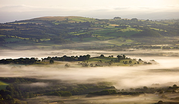 Early morning mist hanging over rolling farmland near Llangadog, Brecon Beacons National Park, Carmartenshire, Wales, United Kingdom, Europe