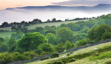 Mist approaches the sloping fields and woodland above the Usk Valley near Llangynidr, Brecon Beacons, Powys, Wales, United Kingdom, Europe