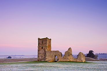 Ruins of Knowlton Church beneath pastel pink skies on a frosty winter morning, Knowlton, Dorset, England, United Kingdom, Europe