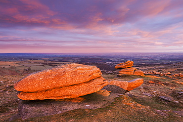 Logan stones bathed in first light of a winter morning, Belstone Tor, Dartmoor National Park, Devon, England, United Kingdom, Europe