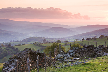 Dry stone wall on the slopes of Sugar Loaf mountain, looking towards the Usk Valley at sunset, Brecon Beacons National Park, Monmouthshire, Wales, United Kingdom, Europe