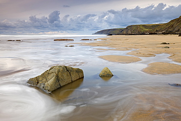 Incoming tide on Sandymouth Beach, Cornwall, England. United Kingdom, Europe