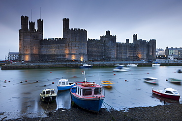 Foreboding evening skies above the immense Caernarfon Castle, UNESCO World Heritage Site, Caernarfon, Gwynedd, North Wales, Wales, United Kingdom, Europe