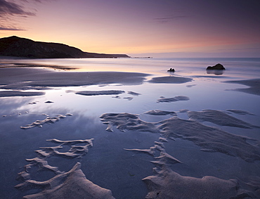 Water pools on the sandy beach at Kennack Sands at sunrise, Lizard Peninsula, Cornwall, England, United Kingdom, Europe