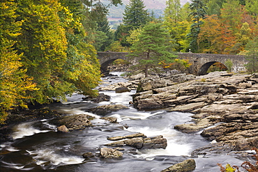 The Falls of Dochart and stone bridge surrounded by autumn foliage at Killin, Loch Lomond and The Trossachs National Park, Stirling, Scotland, United Kingdom, Europe