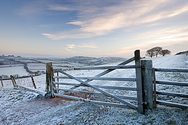 Frost covered wooden gate and field in winter, Raddon Hills, Devon, England, United Kingdom, Europe