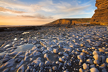 Pebbles bask in the late evening sunlight at Southerndown on the Heritage coast, Southerndown, South Wales, Wales, United Kingdom, Europe