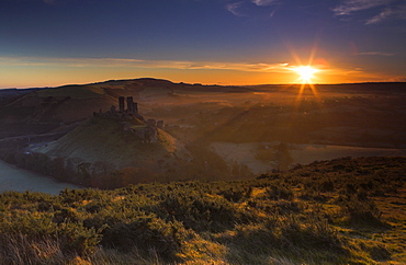 Early morning sunshine warms a chilly morning at Corfe Castle, Dorset, England, United Kingdom, Europe