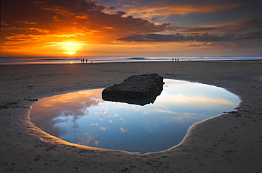 Rockpool and people at sunset, Dunraven Bay, Southerndown, Wales, United Kingdom, Europe