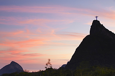 Christ the Redeemer statue (Cristo Redentor) at sunset, Corvocado, Rio de Janeiro, Brazil, South America 