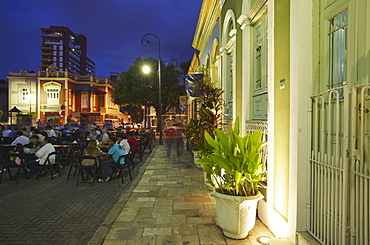 People eating at outdoor restaurants in Praca Sao Sebastiao (St. Sebastian Square) at dusk, Manaus, Amazonas, Brazil, South America 