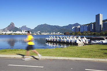 Person jogging on track around Lagoa Rodrigo de Freitas, Rio de Janeiro, Brazil, South America 