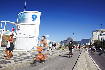 People cycling and walking along pedestrianised street on Sunday, Ipanema, Rio de Janeiro, Brazil, South America 