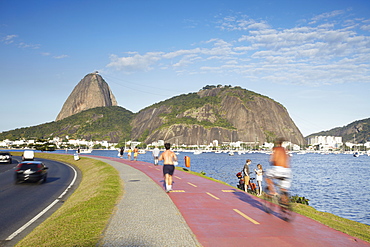 People exercising on pathway around Botafogo Bay with Sugar Loaf Mountain (Pao de Acucar) in the background, Rio de Janeiro, Brazil, South America