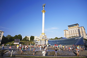 People in Independence Square (Maydan Nezalezhnosti) with Hotel Ukraina in background, Kiev, Ukraine, Europe