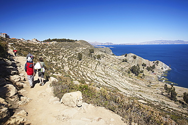 Backpackers hiking on Isla del Sol (Island of the Sun), Lake Titicaca, Bolivia, South America