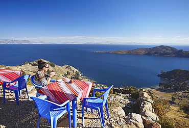 Woman at outdoor cafe on Isla del Sol (Island of the Sun), Lake Titicaca, Bolivia, South America