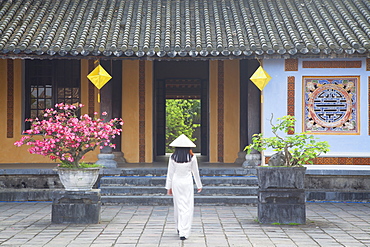 Woman wearing Ao Dai dress at Left House inside Citadel, Hue, Thua Thien-Hue, Vietnam, Indochina, Southeast Asia, Asia