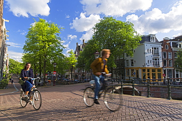 Cyclists on bridge, Amsterdam, Netherlands, Europe