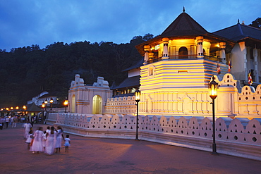 People outside Temple of the Tooth (Sri Dalada Maligawa) at dusk, UNESCO World Heritage Site, Kandy, Sri Lanka, Asia