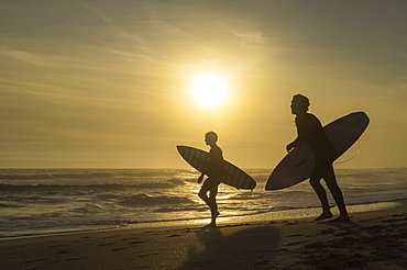 Surfers on Bloubergstrand at sunset, Cape Town, Western Cape, South Africa, Africa