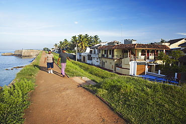 Men walking on walls of Galle Fort, Galle, Sri Lanka, Asia