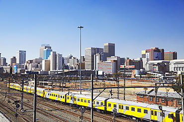 Train entering Park Station with city skyline in background, Johannesburg, Gauteng, South Africa, Africa