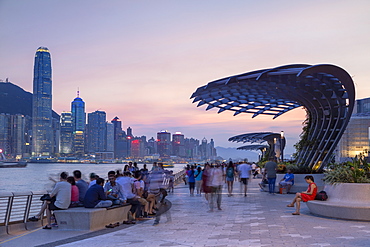 Skyline of Hong Kong Island and Tsim Sha Tsui promenade at sunset, Hong Kong, China, Asia