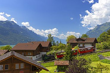 Brienz Rothorn train passing traditional chalets, Brienz, Switzerland