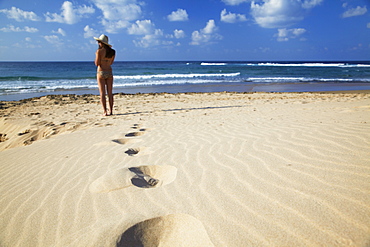 Woman standing on sand dunes, Tofo, Inhambane, Mozambique, Africa