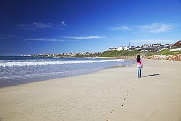 Woman walking on beach at St. Francis Bay, Western Cape, South Africa, Africa