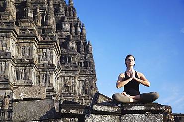 Woman performing yoga, Prambanan complex, UNESCO World Heritage Site, Java, Indonesia, Southeast Asia, Asia