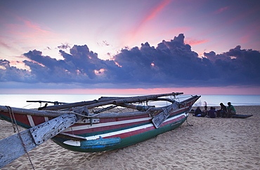 Oruwa (outrigger canoe) on beach at sunset, Negombo, North Western Province, Sri Lanka, Asia