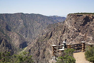 Visitor at Painted Wall View Point, Gunnison River deep in the canyon, Black Canyon of the Gunnison National Park, Colorado, United States of America, North America