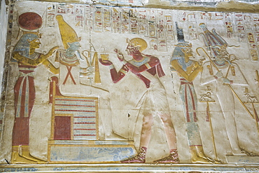 Pharaoh Seti I in center making an offering to the seated God Osiris, Temple of Seti I, Abydos, Egypt, North Africa, Africa