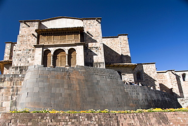 Wall in the foreground of the Inca ruin of Coricancha, with the church of Santo Domingo in the background, Cuzco, Peru, South America