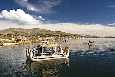 Tourists on reed boat and the floating islands of the Uros people, Lake Titicaca, Peru, South America