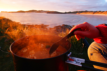 Cooking over a camp stove near Balnakeil Bay, Sutherland, Scotland