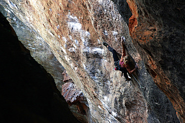 A climber scaling limestone cliffs in the jungle at Serra do Cipo, Minas Gerais, Brazil, South America