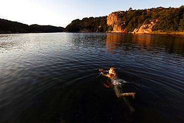 A woman swimming on the Bohuslan coast, Sweden, Scandinavia, Europe