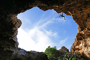 Rock climber in action on the cliffs of Malta, Mediterranean, Europe