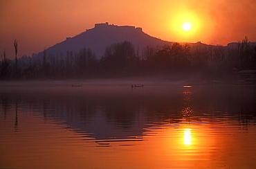 Fishermen make their way home in canoes as the sun sets over Nigeen Lake, Srinagar, capital of Indian-administered Kashmir, India, Asia