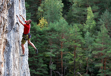 A climber tackles a steep route on limestone cliffs near the mountain town of Bielsa, central Pyrenees, Spain