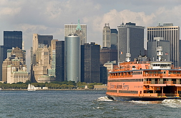 The famous orange Staten Island Ferry approaches lower Manhattan, New York, United States of America, North America