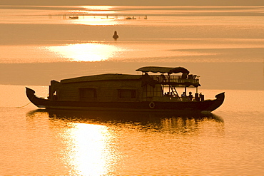 Houseboat at dusk in Ashtamudi Lake, Kollam, Kerala, India, Asia