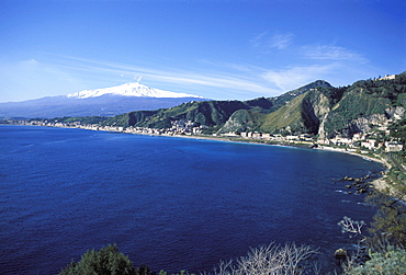 View of Taormina with Mount Etna in the background, Giardini Naxos, Sicily, Italy, Europe