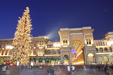 Christmas tree and Galleria Vittorio Emanuele entrance illuminated at dusk, Milan, Lombardy, Italy, Europe