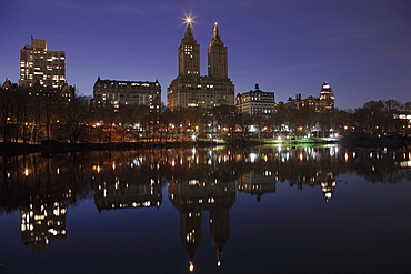 The San Remo Towers, Central Park West skyline at night reflected in the Lake, Central Park, Manhattan, New York City, United States of America, North America